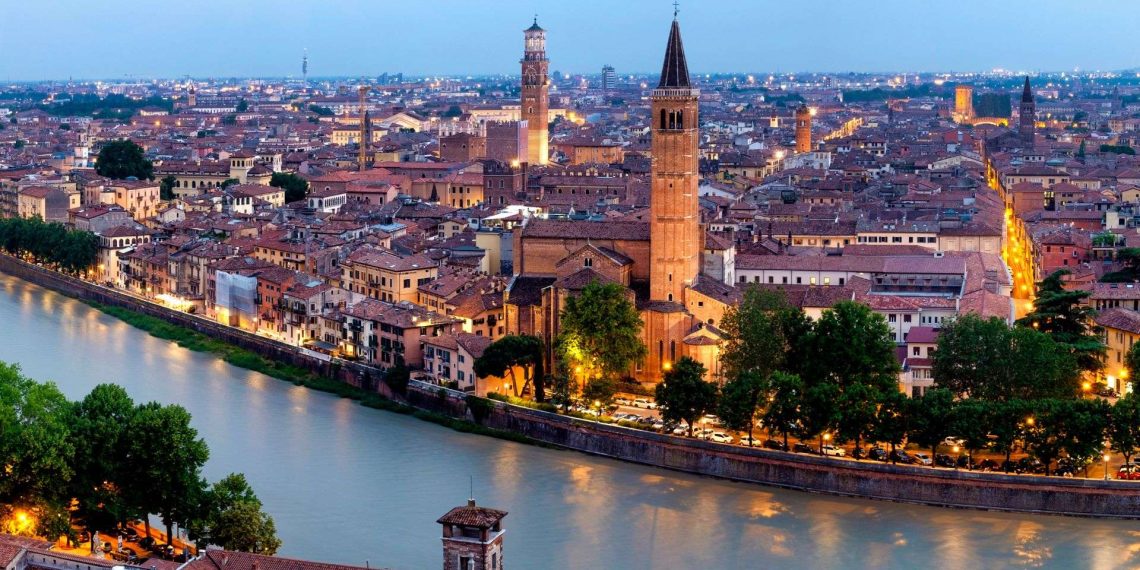 Blick über die Altstadt von Verona mit der Etsch, Brücken und Kirchtürmen in der Abenddämmerung